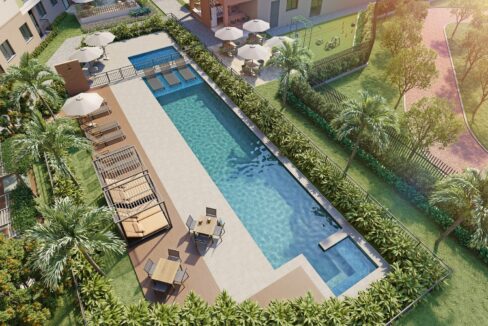 Vista aérea da piscina adulto e infantil do Residencial Dona Ivone Lara, com deck, espreguiçadeiras e jardins