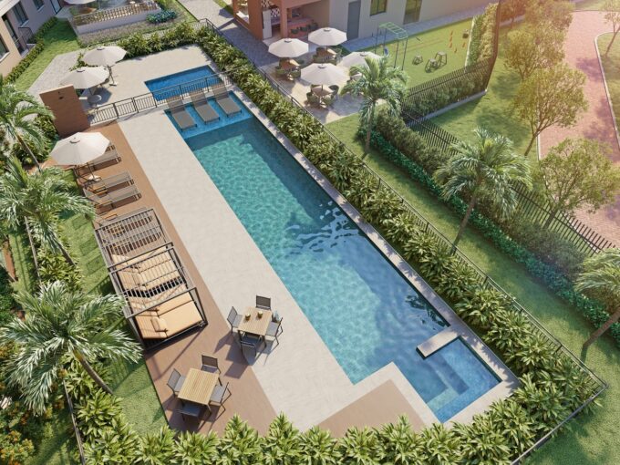 Vista aérea da piscina adulto e infantil do Residencial Dona Ivone Lara, com deck, espreguiçadeiras e jardins